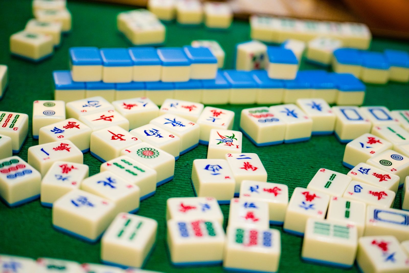 Exposed sets of mahjong tiles laid face-up in front of a player